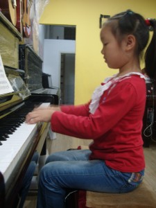 钢琴边的王钰文小朋友像小公主一样